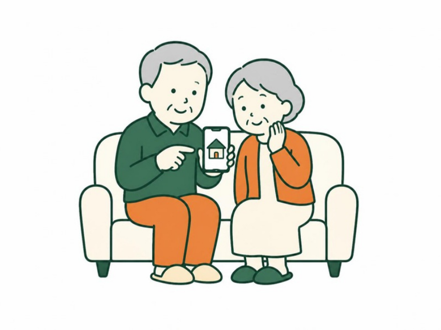 スマートフォンで空き家の報告を見るご夫婦